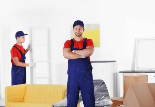 Removal team loading household items into a van