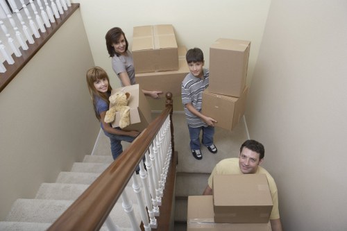 Mover wearing PPE while transporting boxes